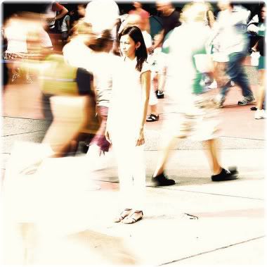 woman standing still in crowd