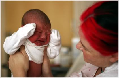 crying baby with mother