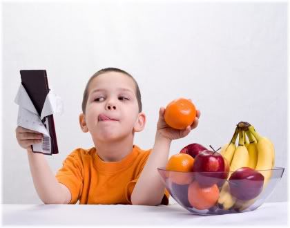 boy holding chocolate and orange