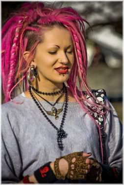 woman with pink hair and ear piercings