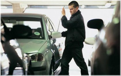 man breaking in to car