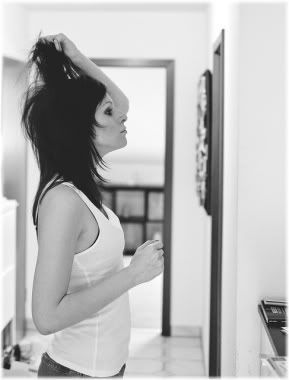 Woman doing hair in mirror