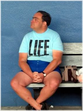 man sitting on bench with life t-shirt