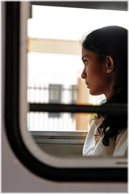 woman looking out of window on train