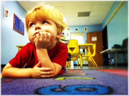 child lying on floor bored