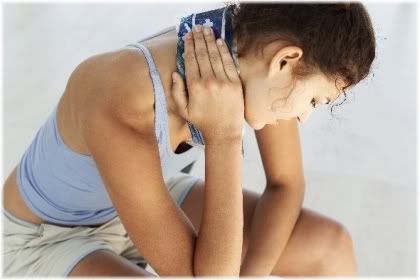 woman holding ice pack on neck