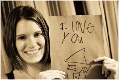 woman holding i love you sign