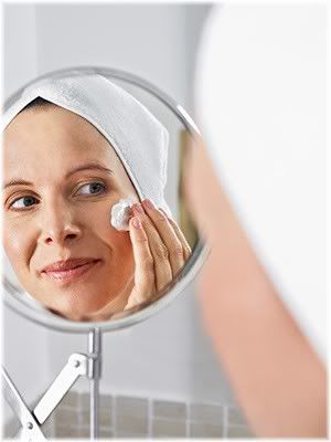 mature woman cleansing face