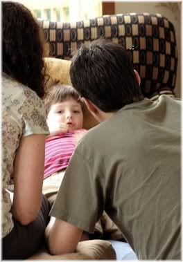 Parents looking at child.